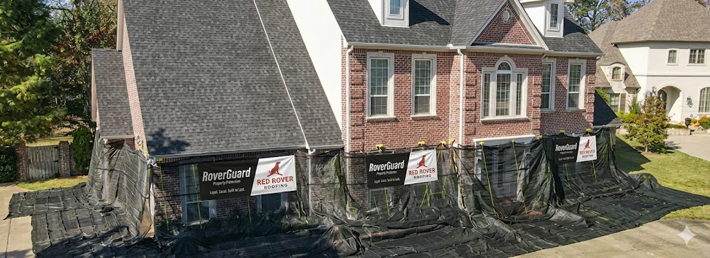 RoverGuard property protection system with branded catchall tarps fully deployed around a brick home during a Red Rover Roofing roof replacement in Middle Tennessee